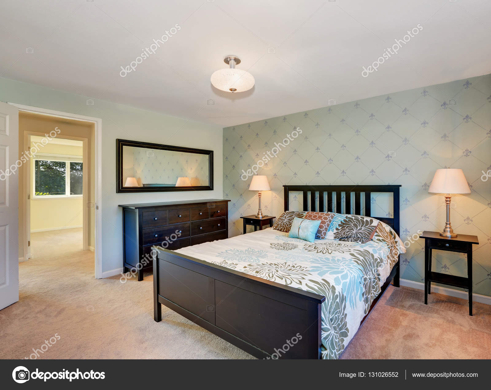 Traditionally Furnished Bedroom With Black Furniture And Carpet