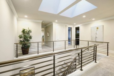 Second floor landing features skylight over the staircase clipart