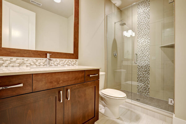 Glass walk-in shower in a bathroom of brand-new home