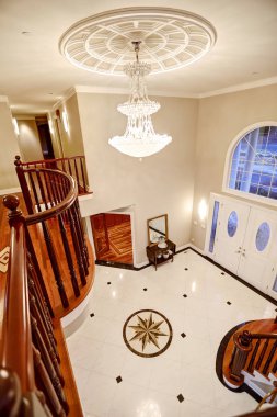 Panoramic view of spacious foyer from staircase landing clipart