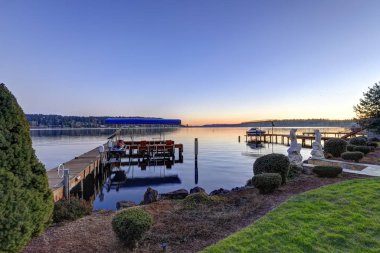 Private dock with jet ski lifts and covered boat lift, Lake Washington. clipart