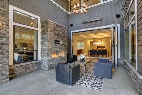 Well designed covered patio boasts stone fireplace — Stock Photo, Image