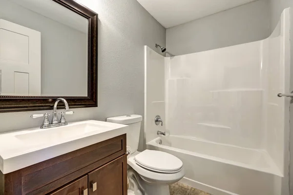 Compact light bathroom with soft gray walls — Stock Photo, Image