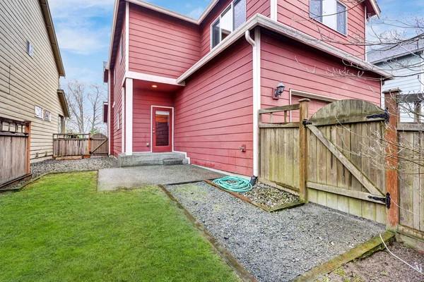 Красный дом снаружи с деревянными воротами — стоковое фото