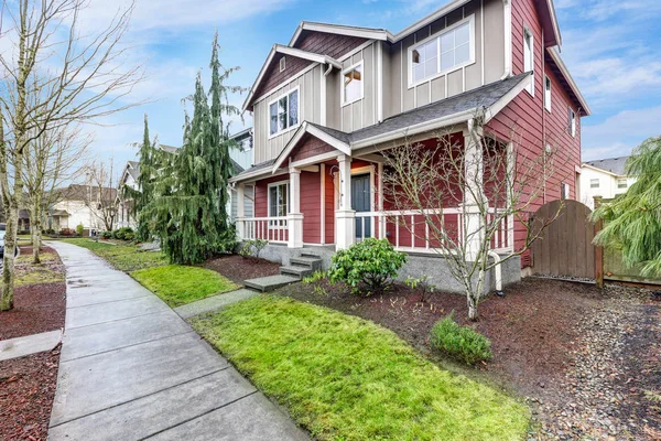 Contemporary Red and grey home exterior with covered porch