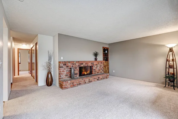 Empty living room features grey walls