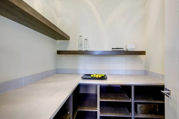 Walk-in pantry features built-in pantry shelves.