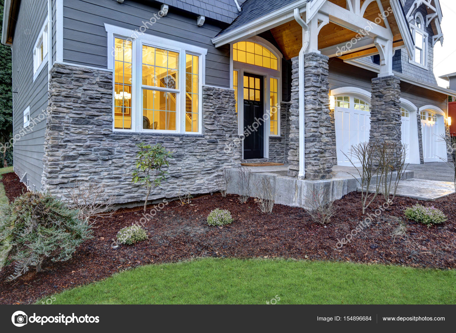 Front covered porch design with stone columns Stock Photo by ...