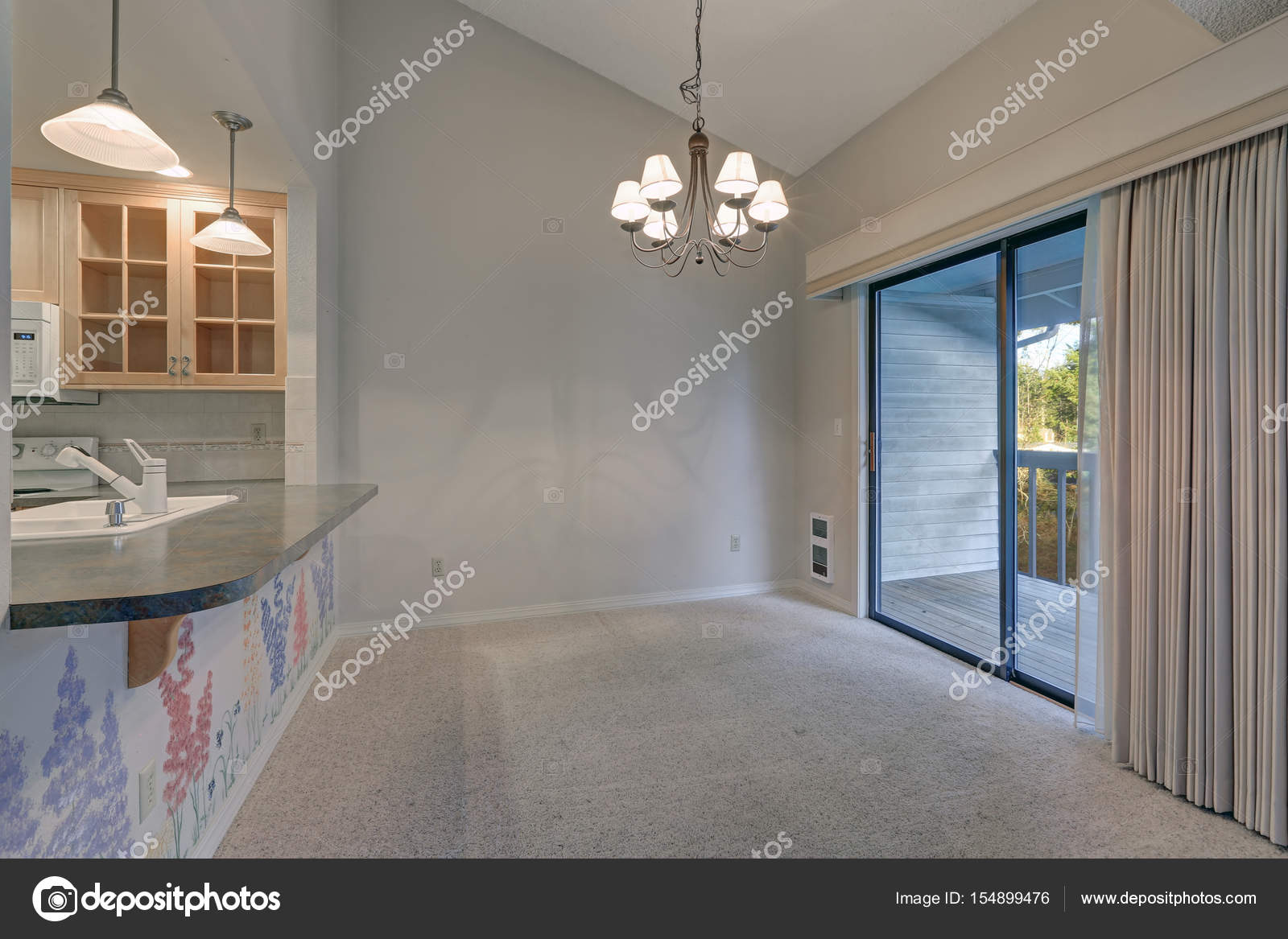 Empty Dining Space With Vaulted Ceiling And Grey Walls