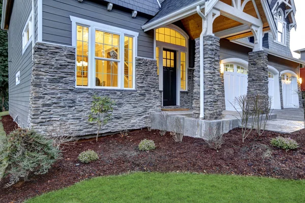 Front covered porch design with stone columns