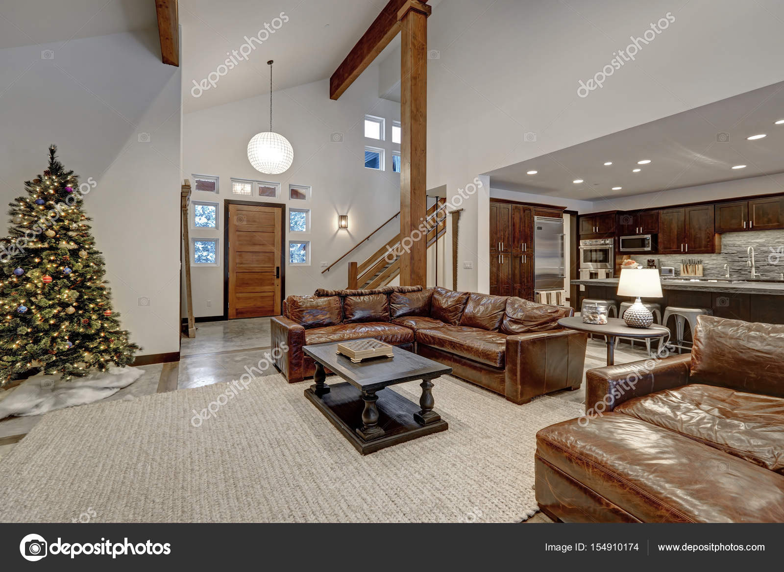 Vaulted Ceiling Living Room With Brown Leather Sofas Stock Photo Vaulted Ceiling Living Room Accented With Wood Beams Over Brown Leather Sofas Open Floor Plan Northwest Usa Photo By Iriana88w