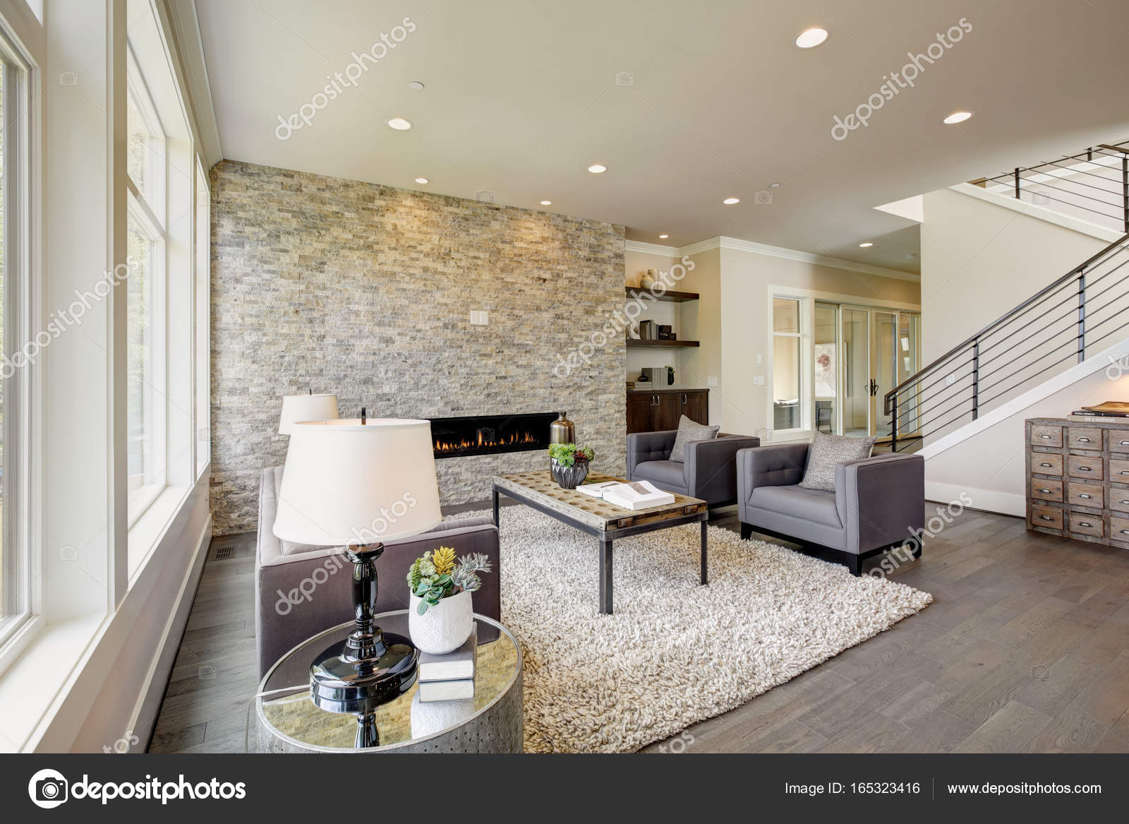 Modern Great Room With A Floor To Ceiling Stone Fireplace