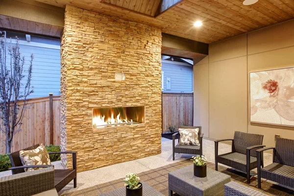 Dreamy outdoor covered patio with stone fireplace — Stock Photo, Image