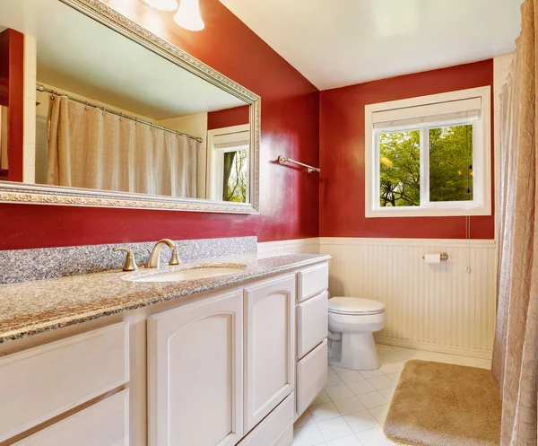 Bright red bathroom interior of a nice rambler house.