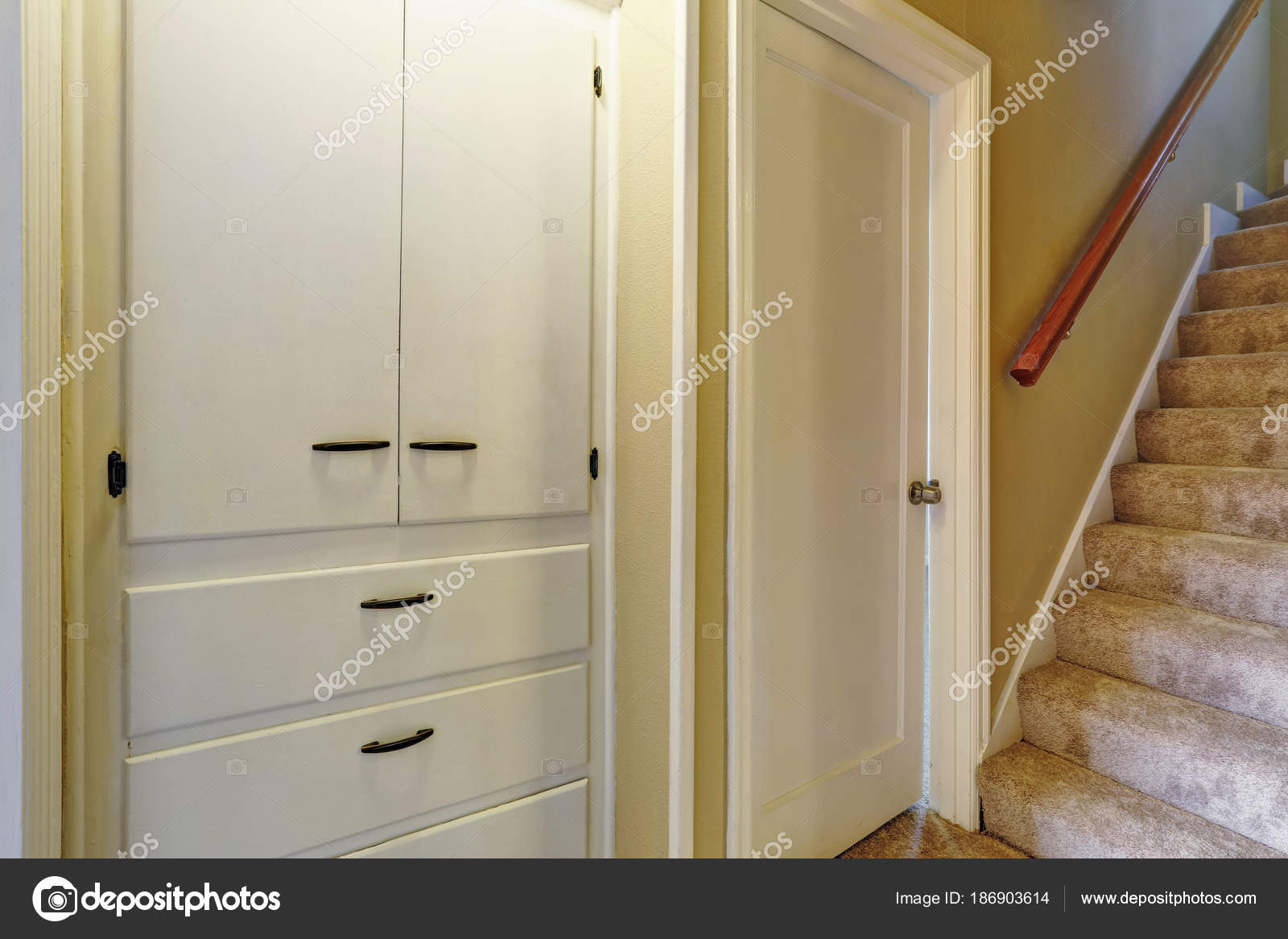 Hallway With Staircase And Built In Cabinets Stock Photo