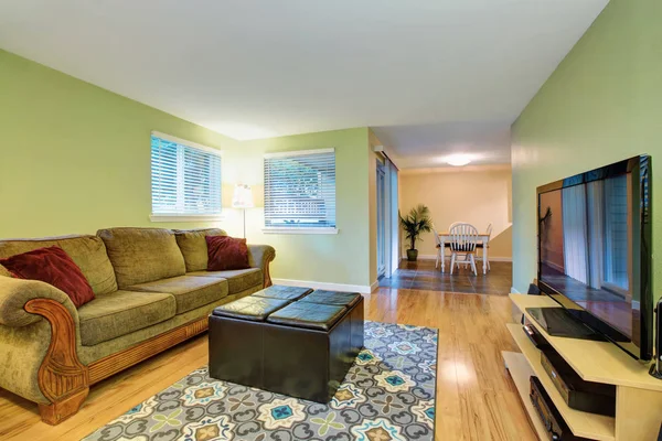 Green family room with adjoining dining area. — Stock Photo, Image