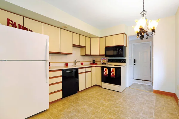 Remodeled kitchen room with cream cabinets.