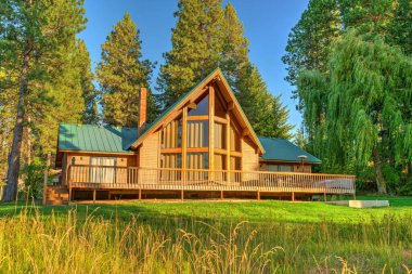 Beautifufl large cedar home with pond and pine trees. clipart
