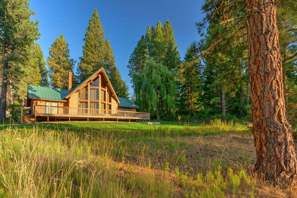 Beautifufl large cedar home with pond and pine trees.
