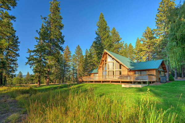 Beautifufl large cedar home with pond and pine trees.