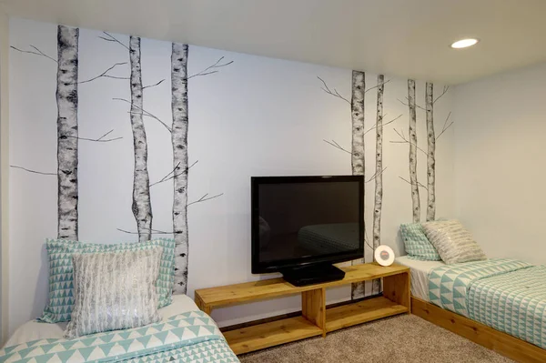 Bedroom interior  with painted birth trees, lght blue bedding, teenagers loft.