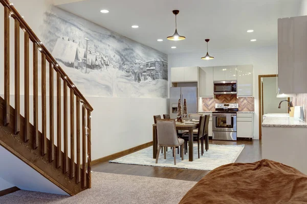 Luxury natural rustic and modern dining room interior design with tall ceiling and mural of old village with loft and blue rug.