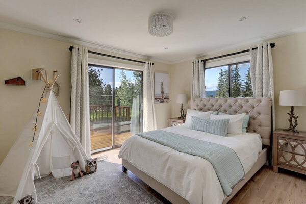 Soft, gentle girls bedroom design with white tent and linen bed with aqua elements of decor.