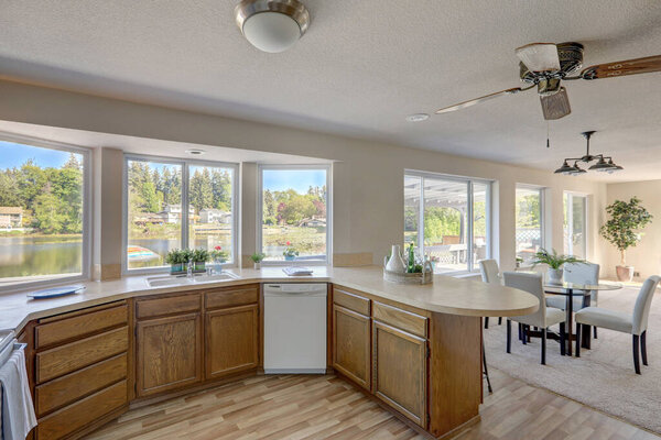 Kitchen interior with older cabinets in American classic lake front rambler house.
