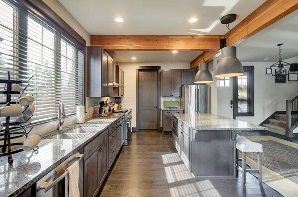 Modern and rustic scandinavian kitchen interior with dark brown hardwood with wooden large beans.
