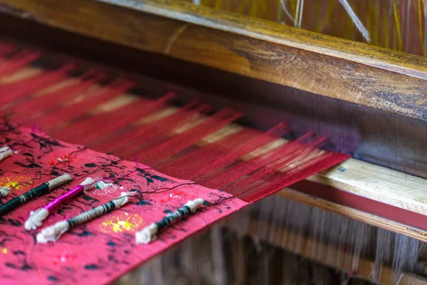 Close-up of a traditional oriental weaving loom. Colorful, bright, traditional handmade scarf