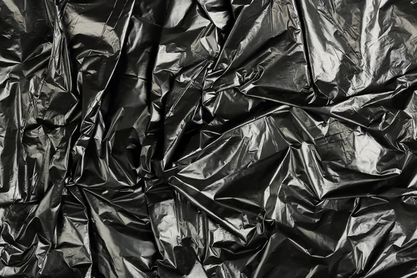 Crumpled black plastic — Stock Photo, Image