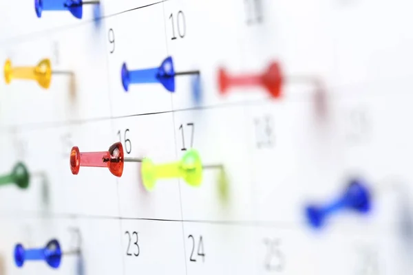 Pushpins on calendar — Stock Photo, Image