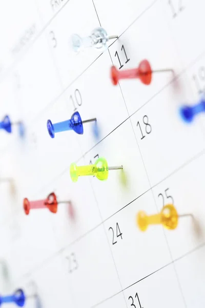 Pushpins on calendar — Stock Photo, Image