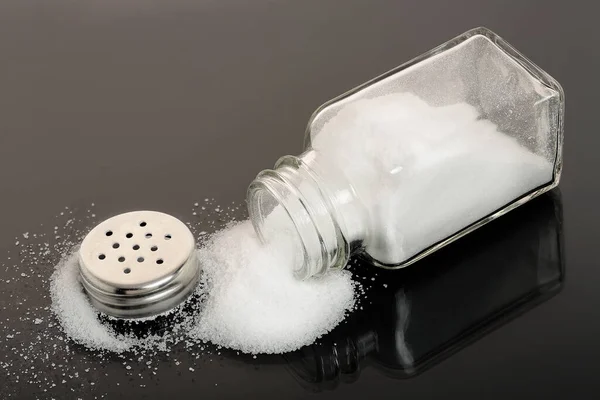 Full Salt Shaker Black Surface — Stock Photo, Image