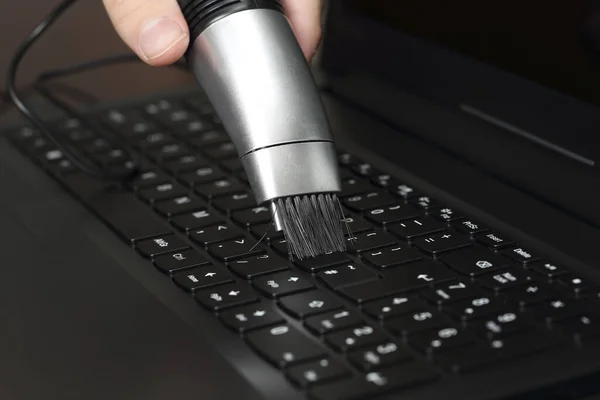 手提电脑键盘上附有微型真空吸尘器 — 图库照片