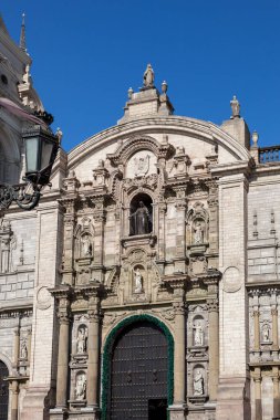 LIMA / PERU - May 10 2016: A Catholic Cathedral in the Plaza de Armas with detailed statues and pillars on the facade in Lima, Peru.