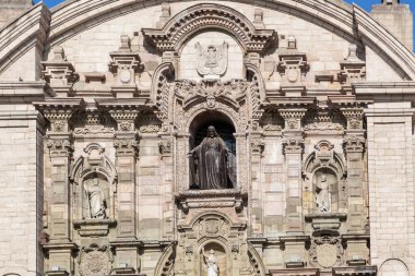 LIMA / PERU - May 10 2016: A Catholic Cathedral in the Plaza de Armas with detailed statues and pillars on the facade in Lima, Peru.