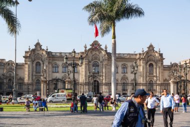 LIMA / PERU - May 10 2016: The Presidential Palace on The Plaza de Armas with people and traffic in Lima Peru.