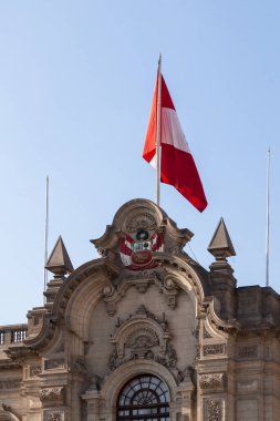 LIMA / PERU - May 10 2016: The side of the Presidential Palace With a flag and the Peruvian Coat of Arms . May 10 2016 Lima Peru.