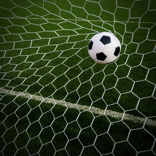 Fútbol fútbol en Goal net con campo de hierba verde . — Foto de Stock