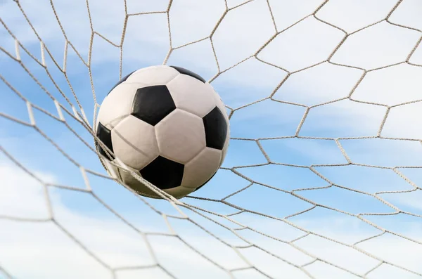 Soccer football in Goal net with the sky field. — Stock Photo, Image