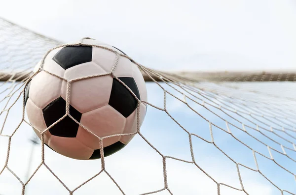 Soccer football in Goal net with the sky field. — Stock Photo, Image
