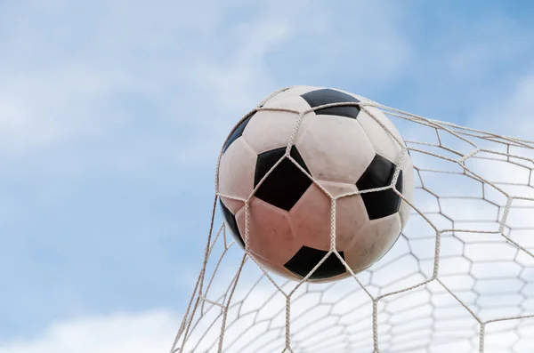 Soccer football in Goal net with the sky field. — Stock Photo, Image