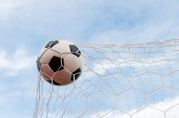Soccer football in Goal net with the sky field. — Stock Photo, Image