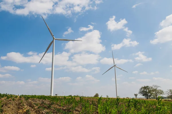 Wind turbine on the blue sky field. — Stock Photo, Image