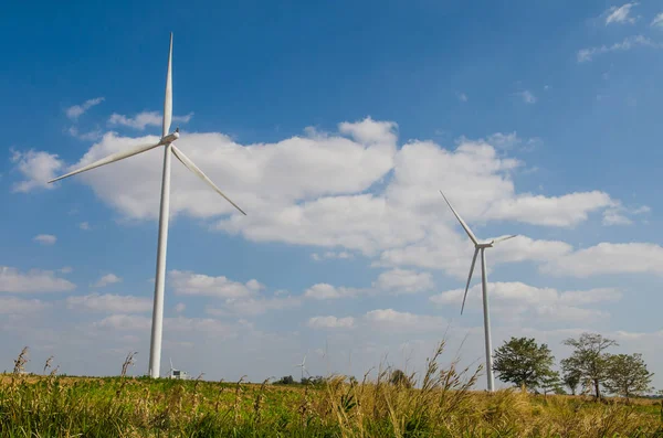 Wind turbine on the blue sky field. — Stock Photo, Image