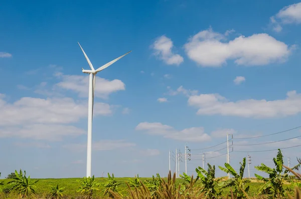 Wind turbine on the blue sky field. — Stock Photo, Image