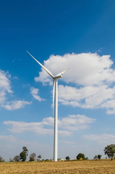 Wind turbine on the blue sky field. — Stock Photo, Image