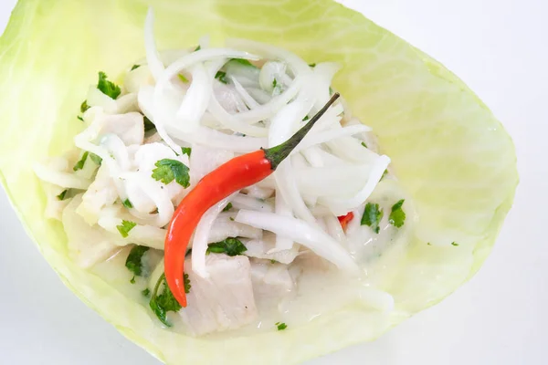 Traditional Latin American food named 'ceviche' or 'cebiche' served in a cabbage leaf