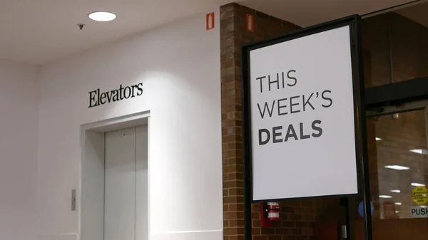 This week's deals billboard beside elevators — Stock Photo, Image